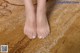 a close up of a person's feet on a rug