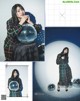 A woman in a plaid coat holding a disco ball.