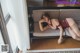 A woman laying on a couch in a red lingerie.